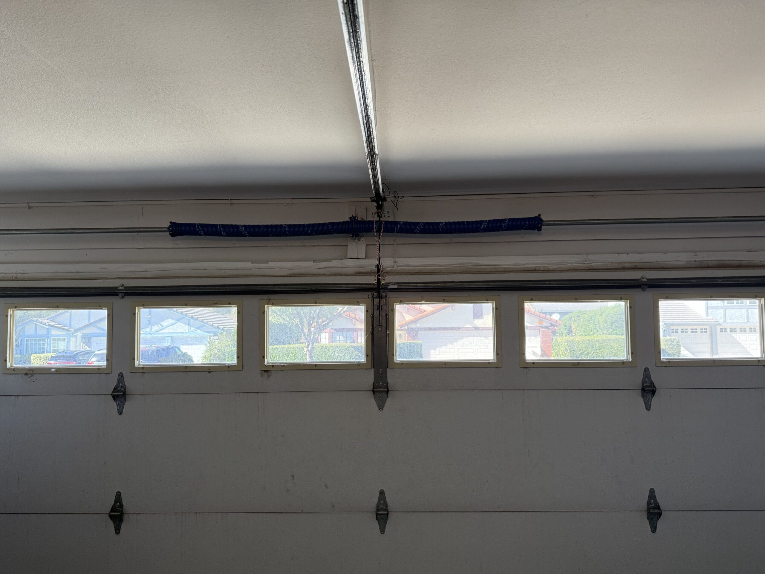 An image of the interior of a garage, featuring a window on the door.